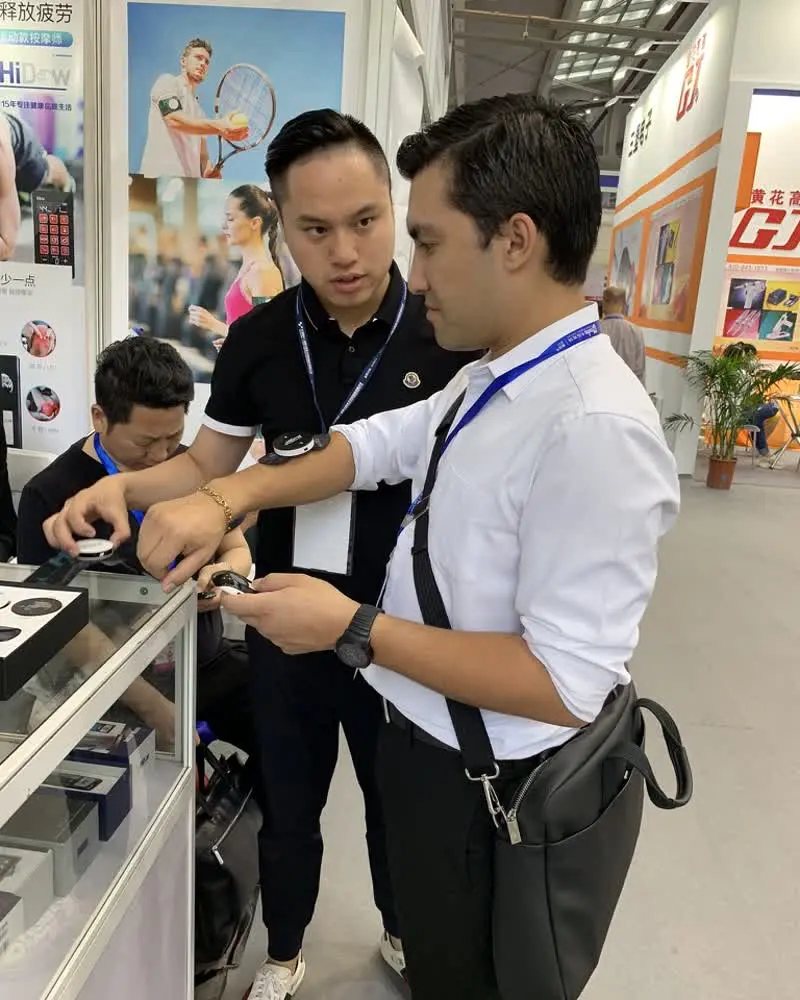 Inspecting wearable product samples with an exhibitor at a trade fair booth