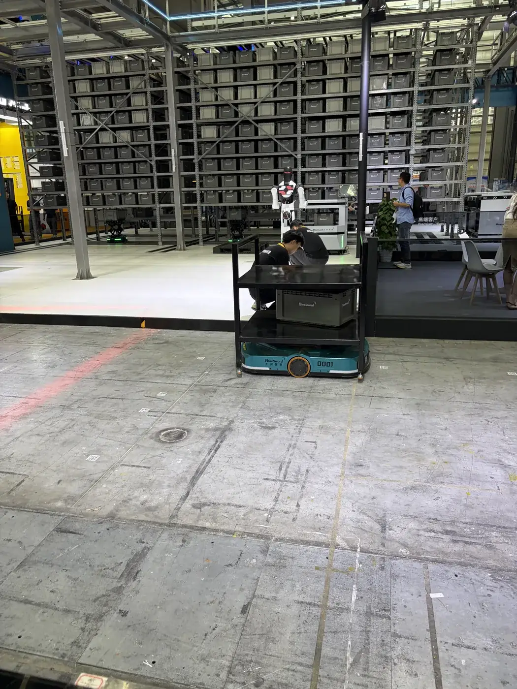 AGV logistics line, warehouse floor · April 2026